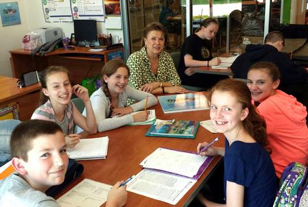 Students doing their homework during “Power Hour” at the Boys and Girls Club of Greater Billerica are joined by Jolanda Creech, corporate support manager of BTU International, Inc.
