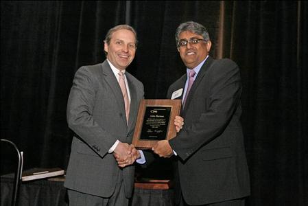 John Hartner, CEO of ECT (left), is presented with an appreciation award from the IPC for serving as the Chairman of the IPC SMEMA Council.